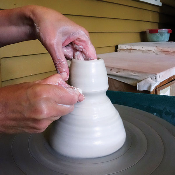 1 Cone up and center ⅓ pound of clay, then open it 2½–3 inches in diameter.