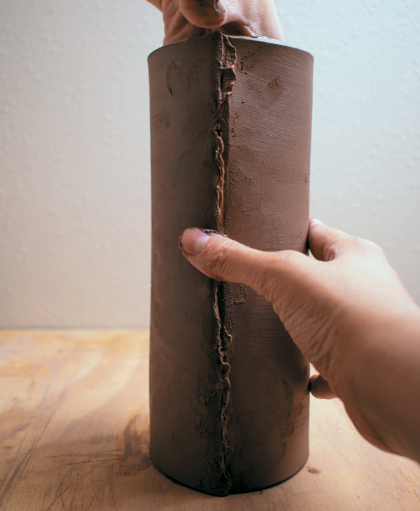 1 Score, slip, and join the ends of a beveled rectangular slab. Smooth the seam.