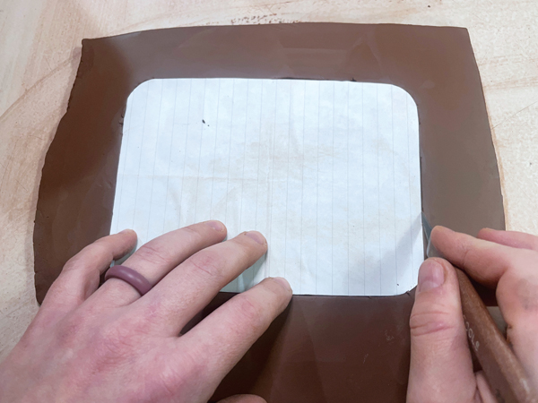 1 Place the template on the slab, then cut through the slab along the edge of the template using a fettling knife. 