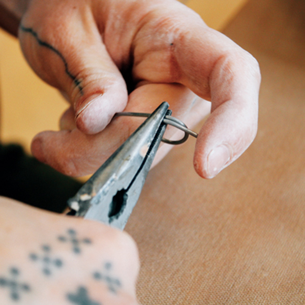 1 Using a needle-nose pliers twist wire into an arced shape and doubled-up loops.