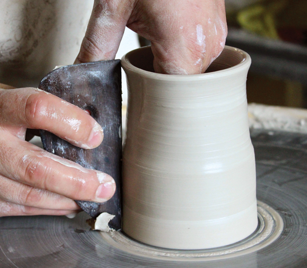 1 Hold the rib with the pointed end down and push out from the inside of the cylinder to form a vertical, ridge-free profile.