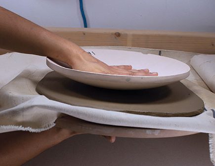1 Stack the mold, slab, canvas, and bat, then flip them over onto the mold.