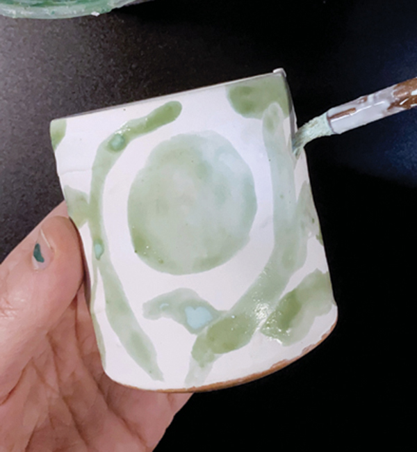 2 Using a wax-filled brush, draw anywhere you would like to have glaze remain.