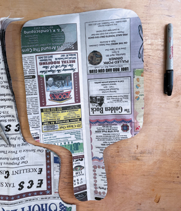 2 Cut out the design. Use several sheets of newspaper to create multiple templates.
