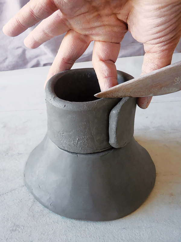 2 Layer the cylinder on top of the cone to begin building your base.