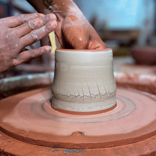 3 Place your hand on the inside and spin the wheel slowly. Using your hands or a sponge, apply even outward pressure.