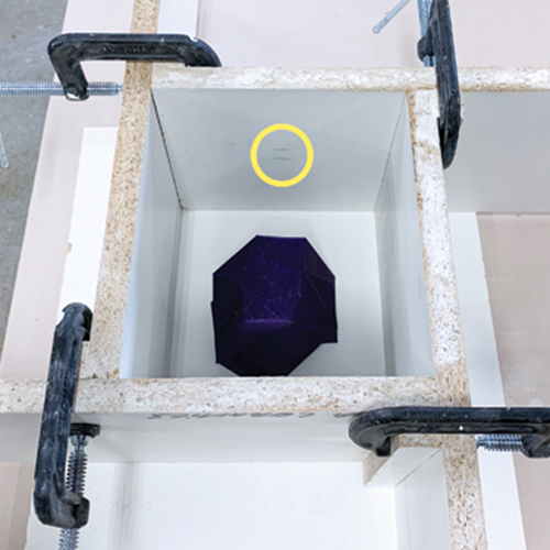 3 Secure the model, set up cottle boards to contain the plaster, and mark the fill line.