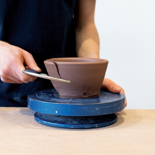 4 With a carving bow, carve a facet following the curvature of the bowl’s interior.