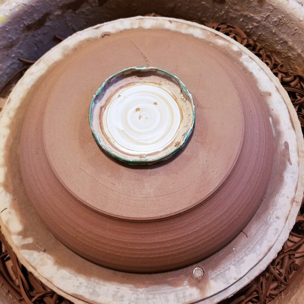 4 Center the plate. I tap to center and use an old jar lid to hold the plate down.
