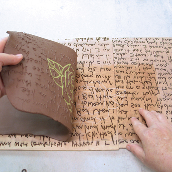 4 Carefully peel back the clay slab from the plywood stamp.