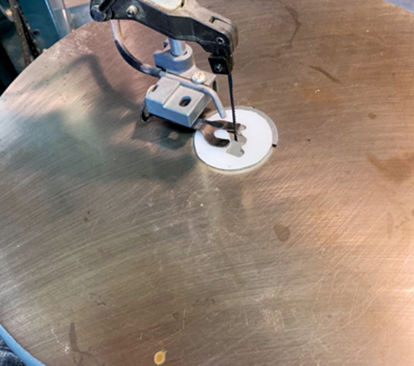 4 Drill holes, then cut out the die with a scroll saw or a coping saw and a vise. 
