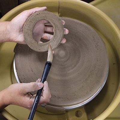 3 Make a coil foot, score the entire slab and foot with a serrated rib, then attach the foot ring.