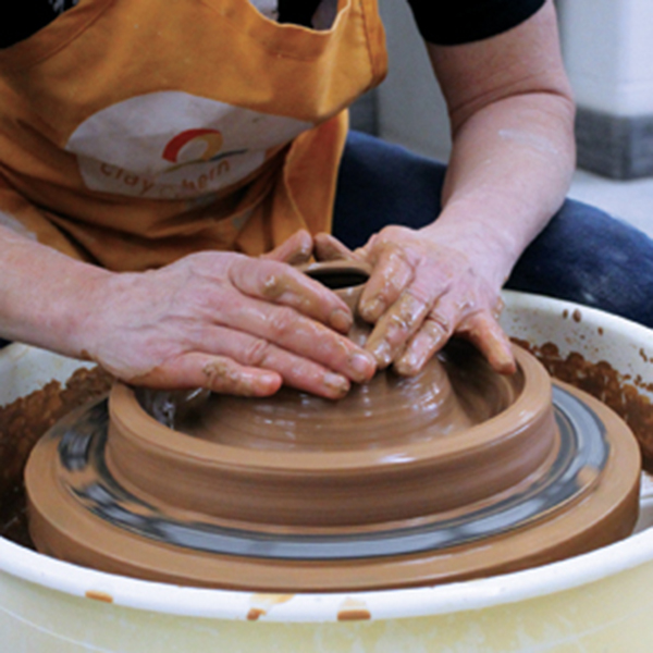 5 Continue to close the form by collaring in the cone and re-pulling up the wall to thin out the clay as it narrows in.