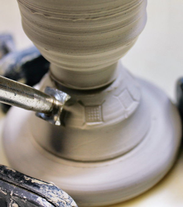 6 Add stamped details to the base when the egg cup reaches soft leather hard.