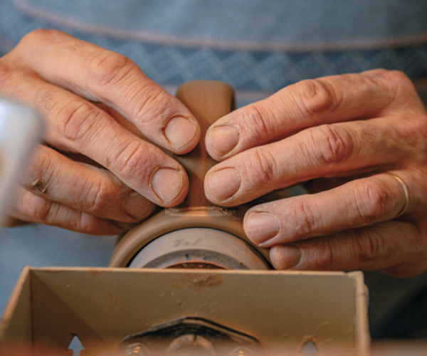 F Mug handles applied by hand. Photo: Mike Belleme.
