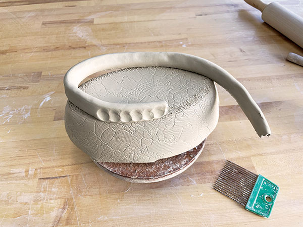 6 Attach a thick coil to the top of the fitted oval drape mold to start the foot.