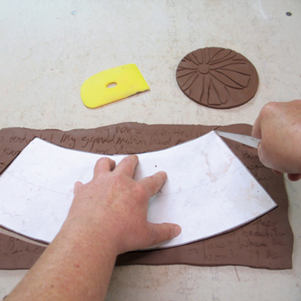 6 Once the slab has stiffened slightly, use the template to cut out the shape.