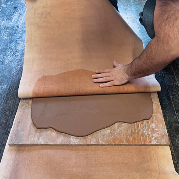 7 Flip the clay, board, and canvas over. Remove canvas from the clay.
