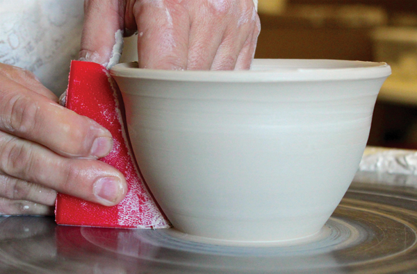 7 Push out against the rib to shape and clean the outside of the bowl. Use the rib’s curved top to make a laid-over rim.