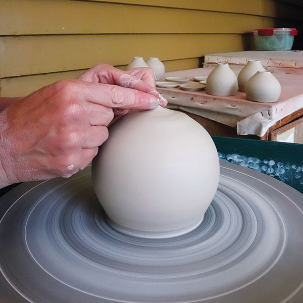 2 End each pull by guiding the clay inward until the form can be pinched closed at the top. 