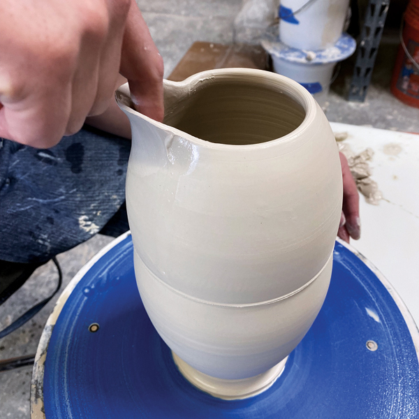 8 After pulling and defining the spout, exaggerate the throat of the spout to further help with pouring.  