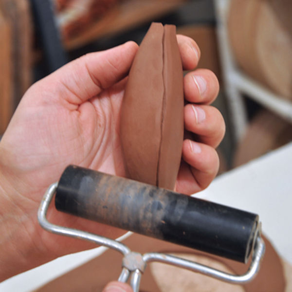4 Once you have the handle shape you want, use a small brayer to compress the seams while leaving the join visible.