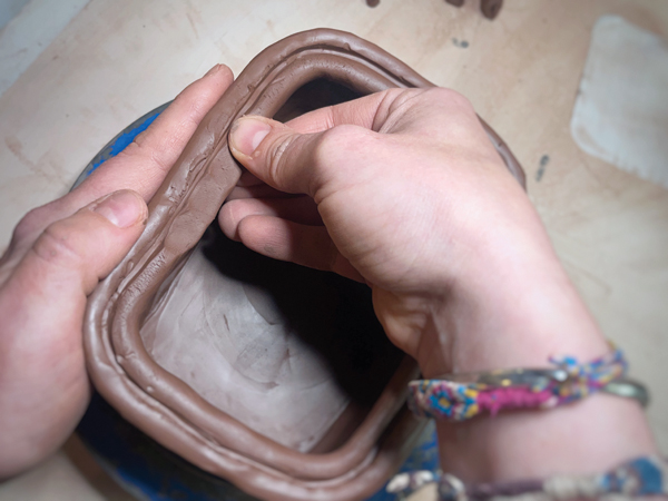 8 Using a thumb and index finger, pinch the coil to taper it—thicker toward the wall and thinner toward the interior.