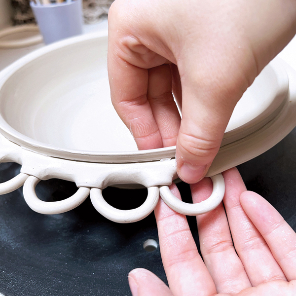 8 Place a ring underneath the rim lip and fold it over the ring, securing it in place.
