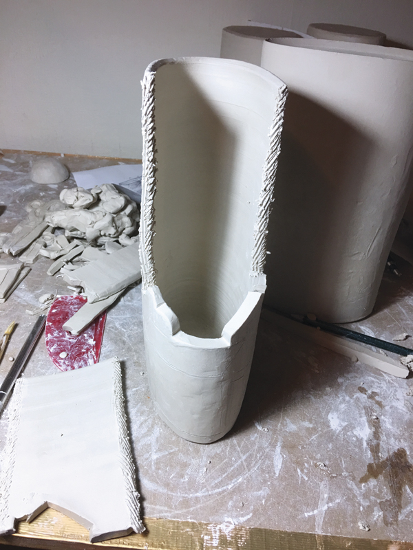8 Score the edges of this piece using a serrated rib and attach with water.