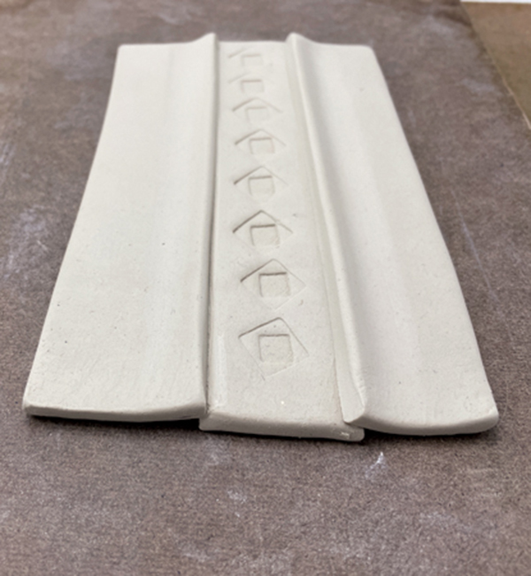 9 Bevel and score the center strip, overlap the pieces, and reassemble. Smooth the seams.