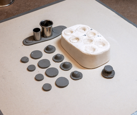 9 Create feet using a mold and a disk cutter. Attach a disk to the top and bottom of each foot.