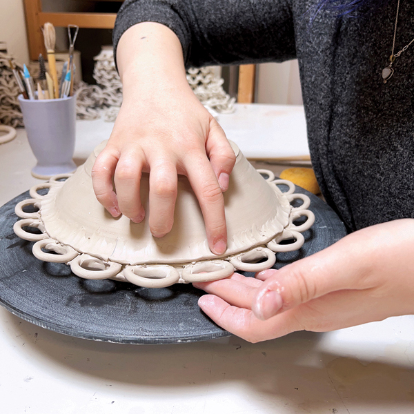 9 After the rings are attached, flip the base over to add a coil around the underside.