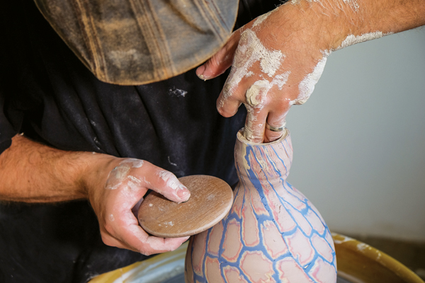 Again, forming the vessel using pressure from one hand inside the piece and pressing against it with wooden roller on the outside.