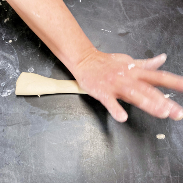 10 Roll an hourglass-shaped coil, then use the heel of your hand to flatten the coil and thin the edge. 