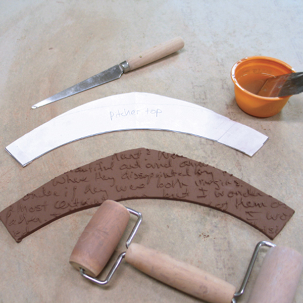 10 Roll a slab, press it into the stamp, and cut out the shape of the top of the pitcher.