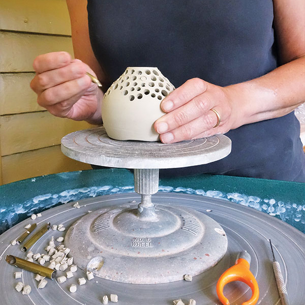 5 Begin piercing tealight covers along the top, where the clay dries fastest.