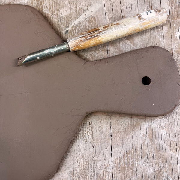 11 Use a clay hole punch or carve a hole into the handle.