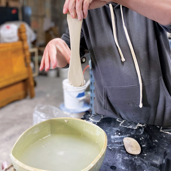 11 While holding the handle, use the webbing between your wet fingers to compress the handle edges.