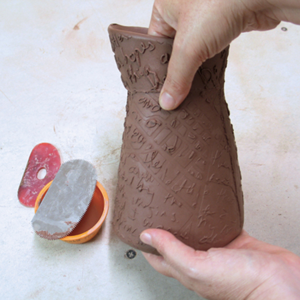 12 Attach the pitcher’s top to the body after scoring and applying slip to the edges.
