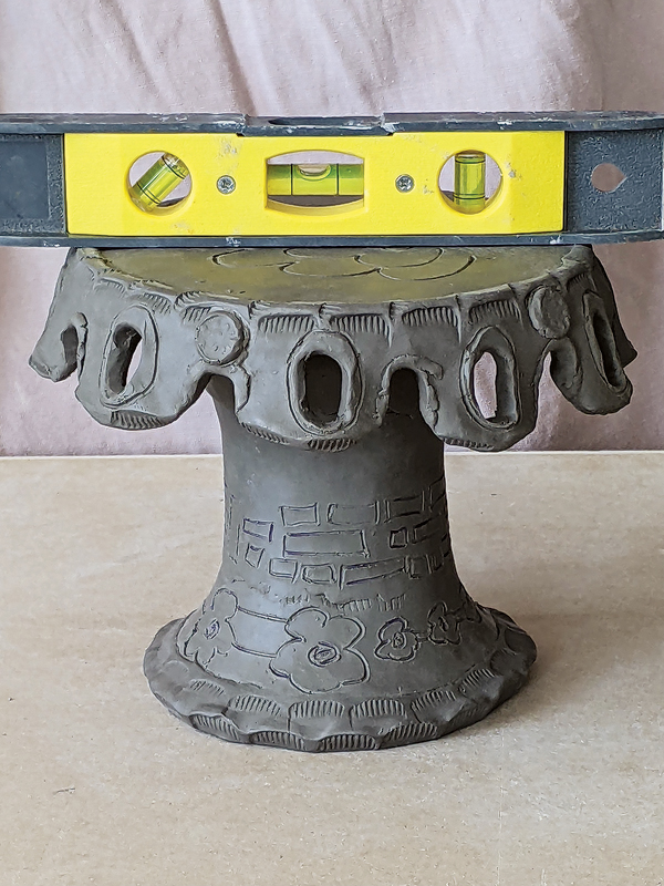 12 Trim or add clay to the top of the base, as necessary, to ensure it is level.