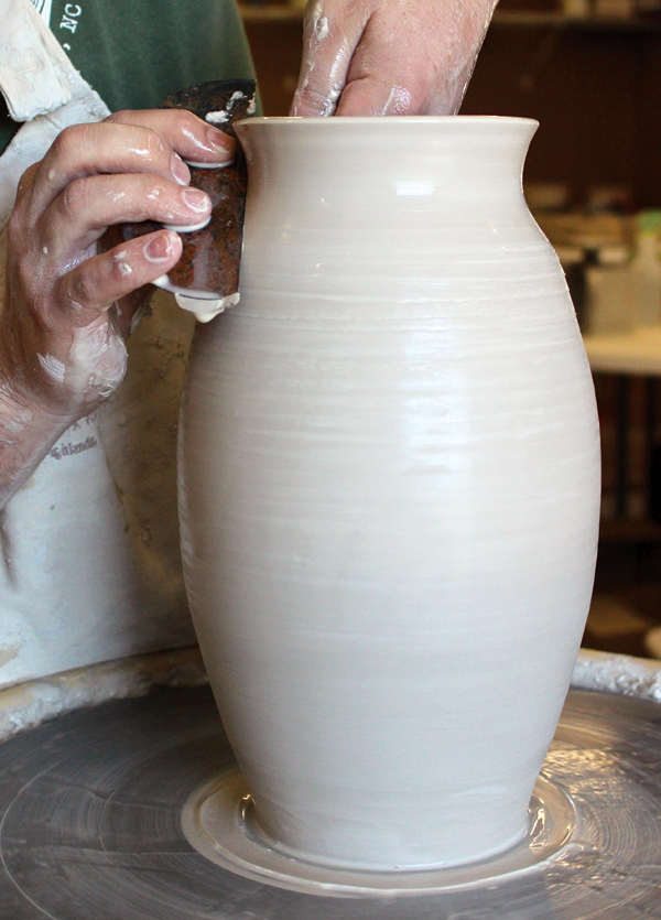 12 Refining with the metal rib compresses and reinforces the form’s walls while removing ridges and excess moisture.