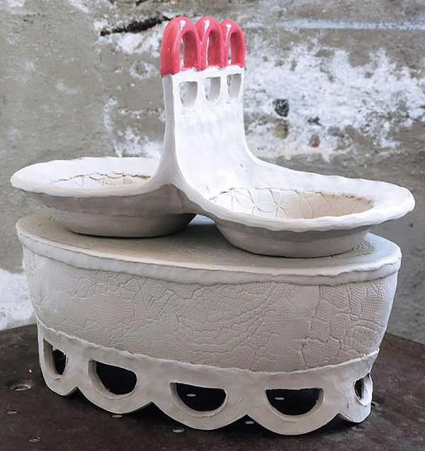 14 Make more cutouts similar to the others and color the coil loops with underglaze.