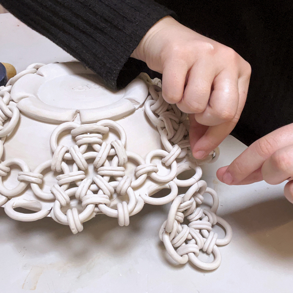 14 Use a 34-gauge nichrome wire to add the flower patterns to the outside edge.