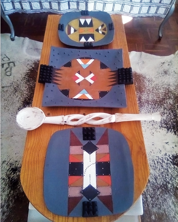 2 Plates and platters by Cele that demonstrate his many interpretations of iziqhaza earplug designs. 