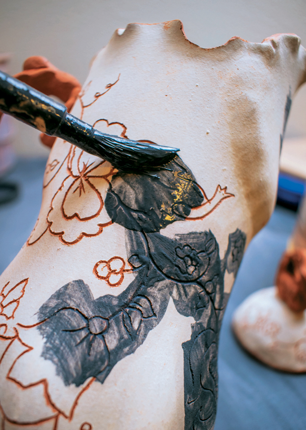 15 Apply black underglaze to the bisque-fired pot. Let dry for several minutes.