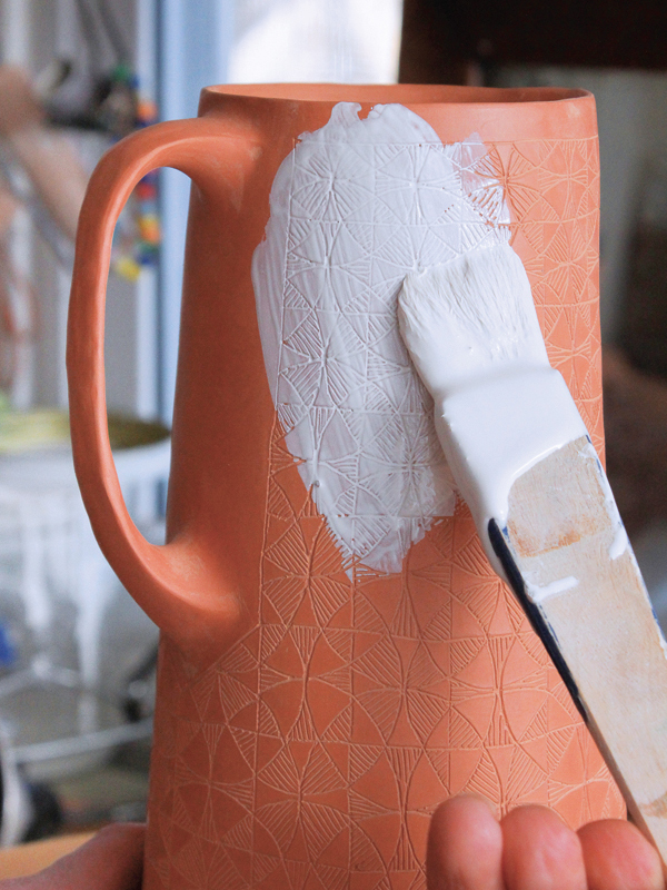 18 Using a hake brush, work in small sections to apply a layer of underglaze to the bisqueware.