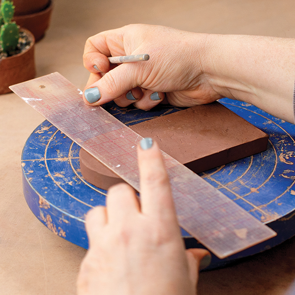 2 Mark and score a line 2½ inches from the curved edge of the largest piece. 