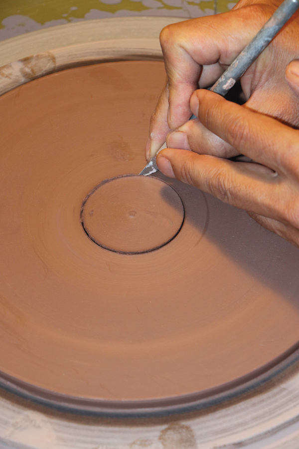 3 Cut a hole slightly smaller than this measurement into the center of the plate.