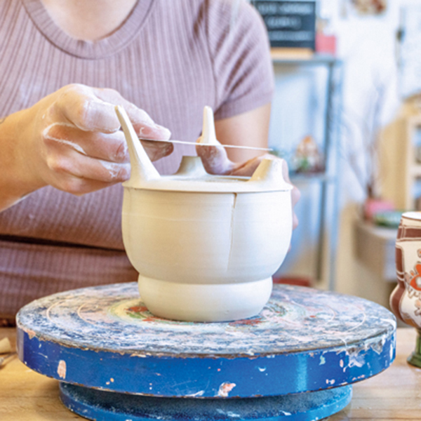 3 Cut excess clay from the feet, then check that the mug sits evenly and is level.