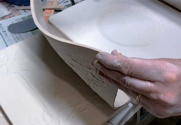 G Removing my porcelain slab to place on the bat with the recessed center to create a rainbow over the landscape.  A, B, F, G Photos: Ann Woodard.